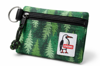 Chums Surfshorts Wallet in green pine tree print with black zipper and key ring on white background