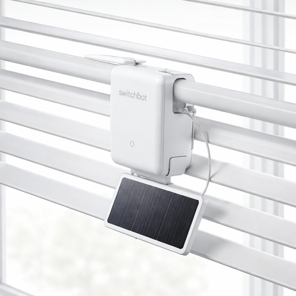 SwitchBot Blind Tilt controller clipped onto horizontal blinds with solar panel