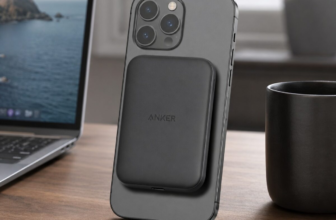 Anker 621 MagGo portable charger attached to iPhone on wooden desk