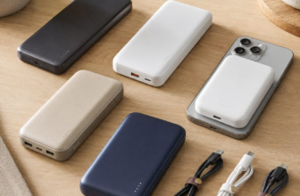 Portable power banks and USB cables arranged on wooden desk with MagSafe charger