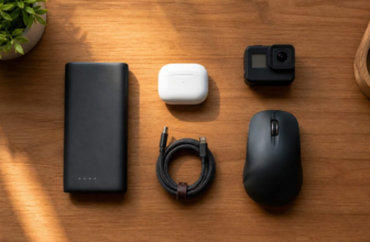 Modern tech gadgets including power bank and wireless mouse on a wooden desk with natural light