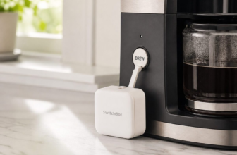 SwitchBot Bot smart button-pusher device on a kitchen counter next to a coffee maker