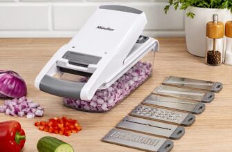 Mueller Vegetable Chopper white and grey with clear container and blades on a kitchen counter